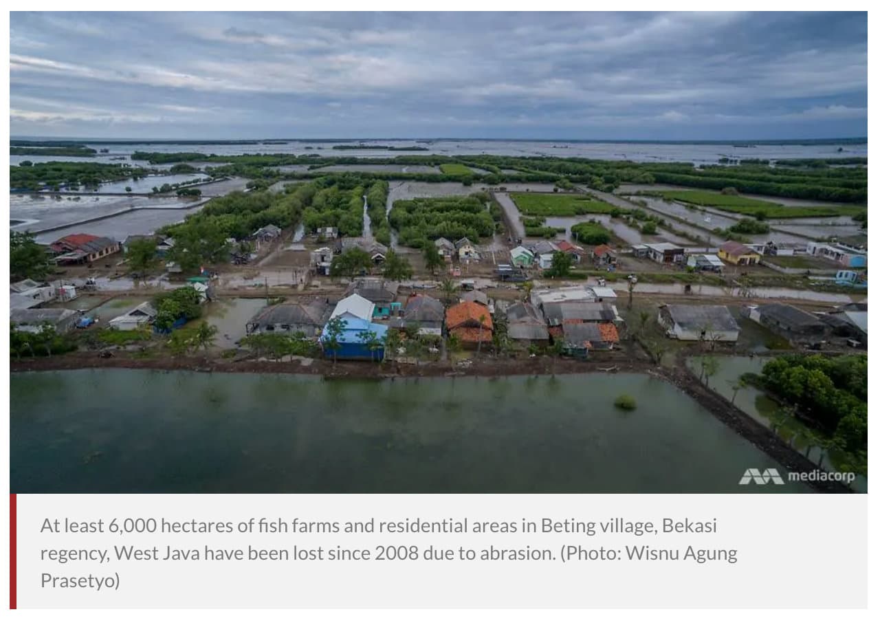 Aerial view of flooded fish farms and homes in Beting village
