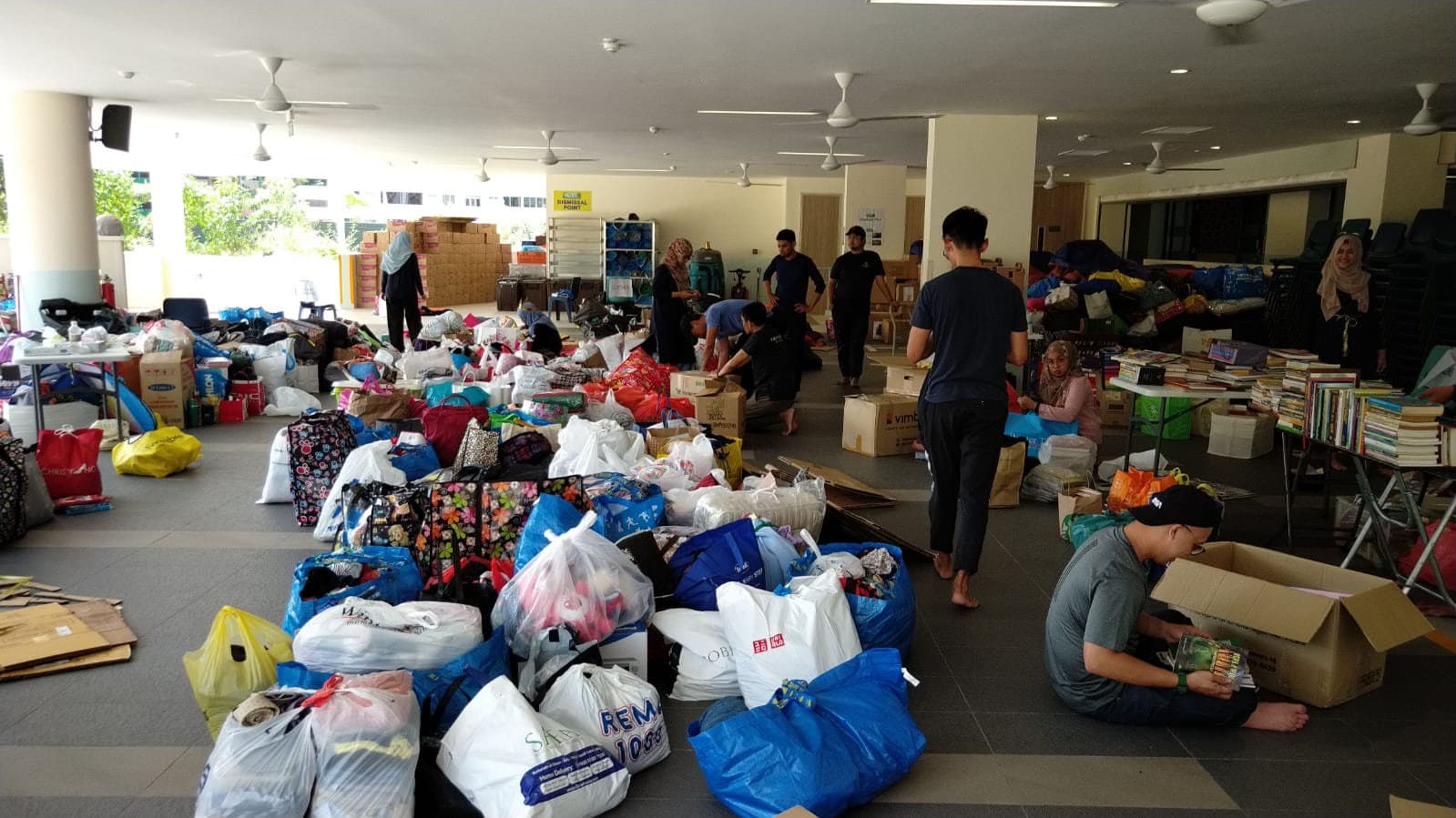 Volunteers sorting donated pre-loved items at the Eco-Bank collection drive