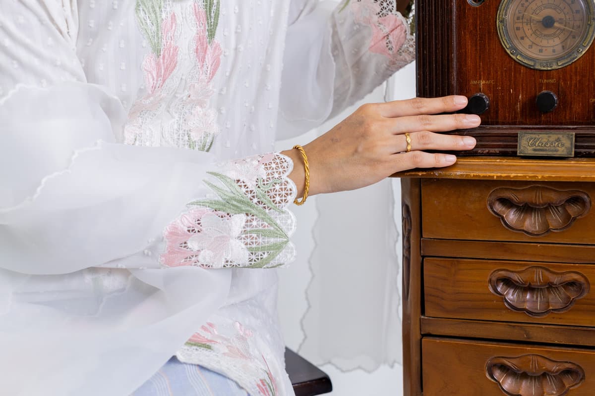 Hand-embroidered detail on the Kuntum Kebaya Panjang in white