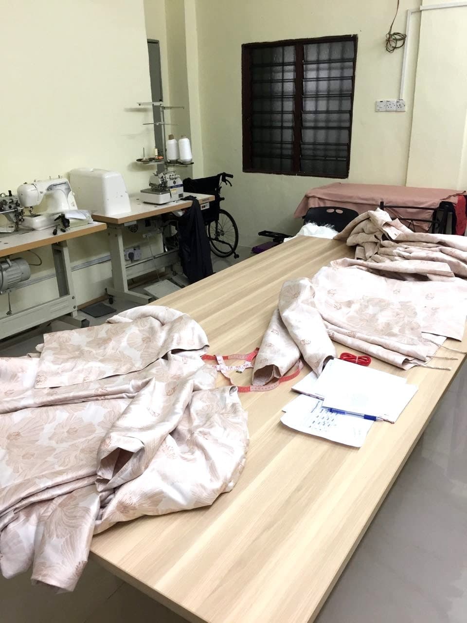 Cut fabric pieces laid out on a cutting table in our production workroom